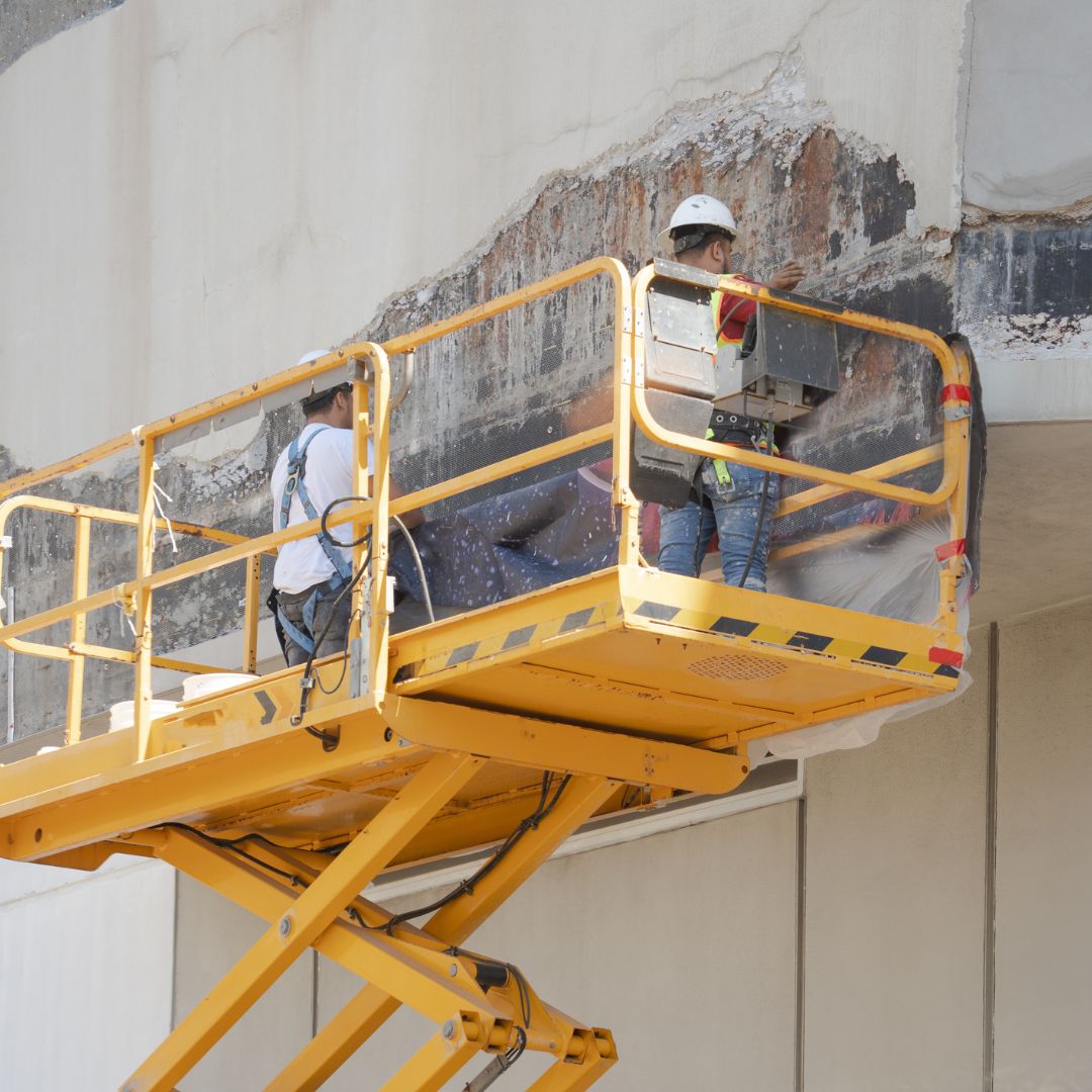 Workers repair building from hurricane damage